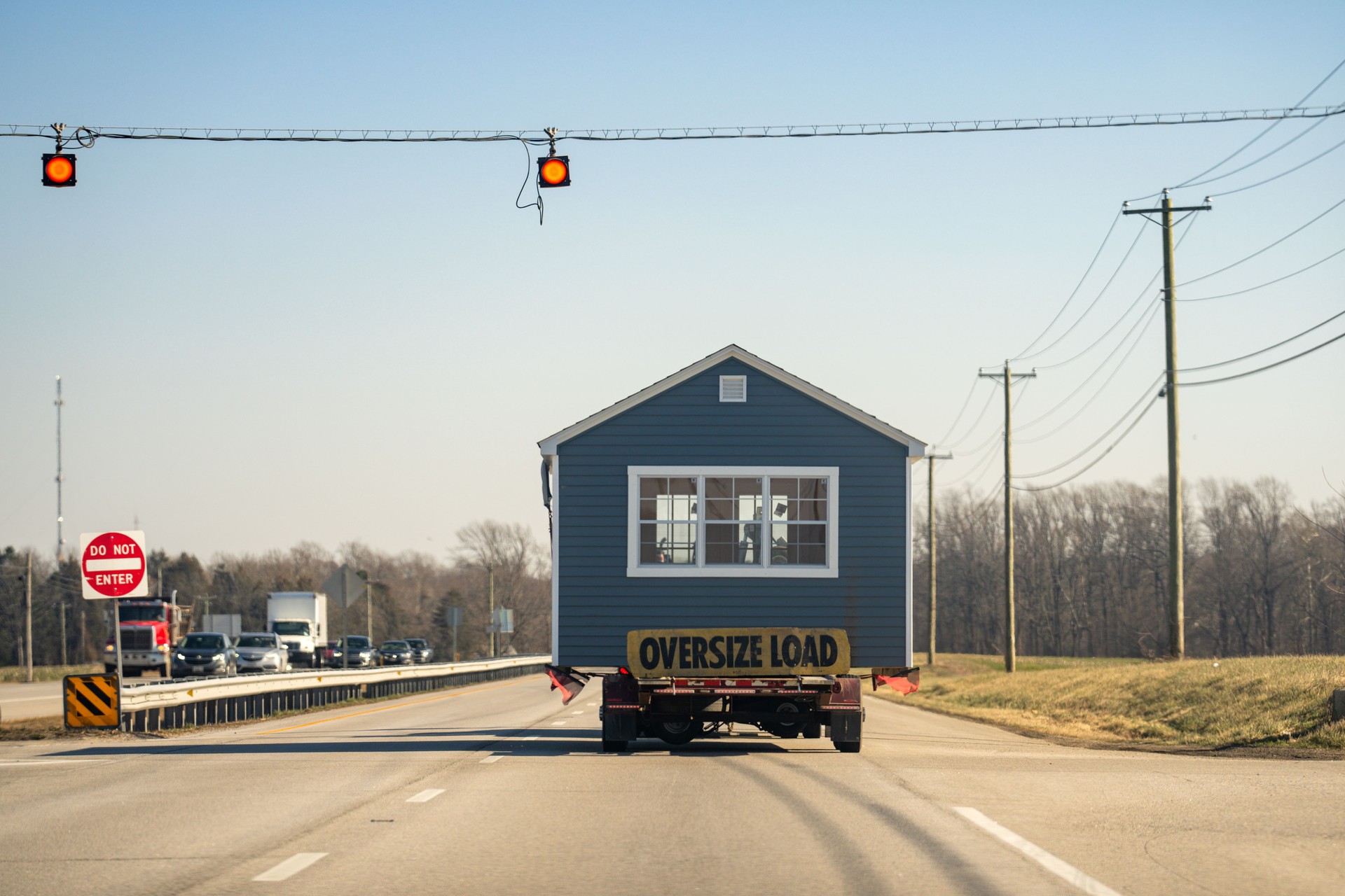 Oversize load. Manufactured house transported on the highway. Mobile Home oversize load on the road. Transporting portable homes. Oversized cargo. Truck Oversized transport. Environment and logistics.