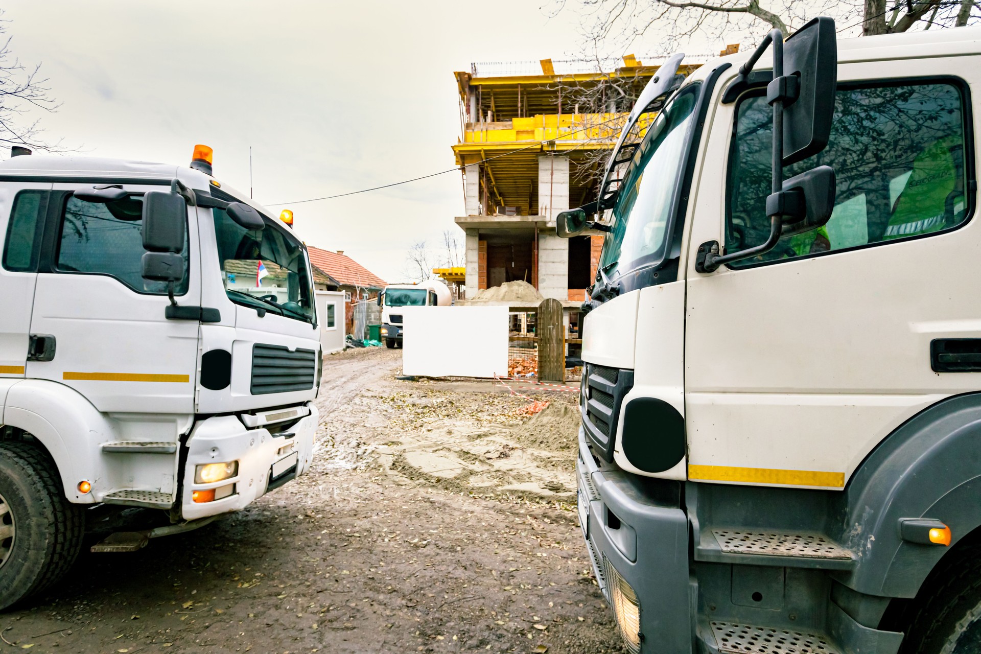 Mixer trucks waiting to delivery concrete at building site